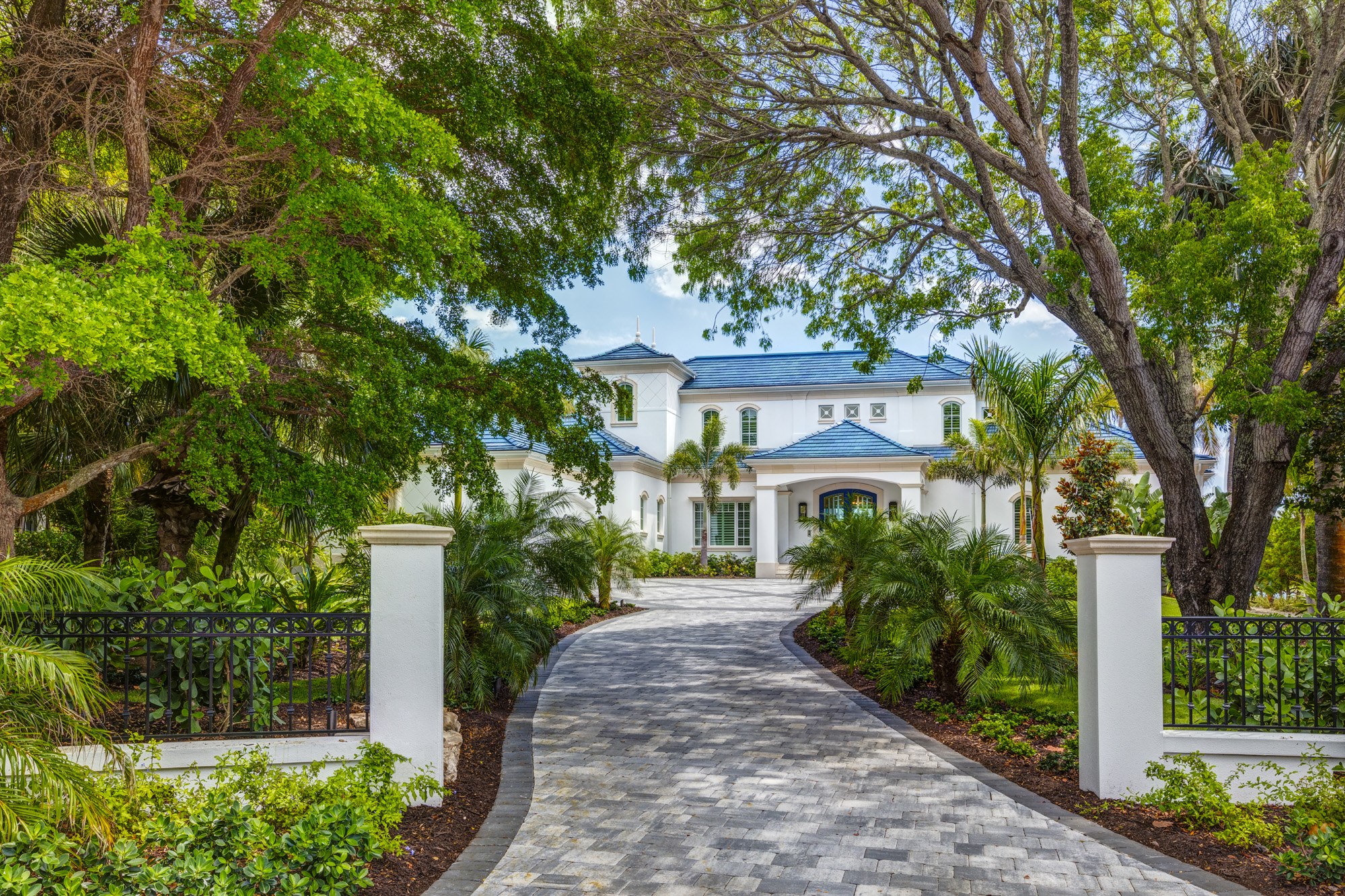 Award-winning Sarasota architects designed this hurricane-resilient Bird Key home with a grand tree-lined approach.