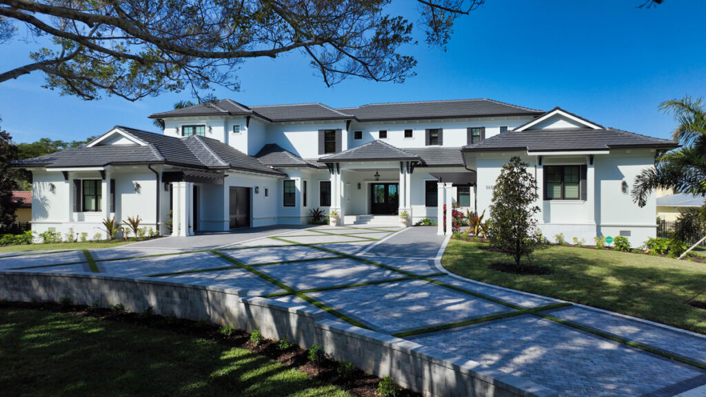 Front exterior view of a two-story Florida residence featuring balanced rooflines, refined detailing, and a timeless architectural composition.