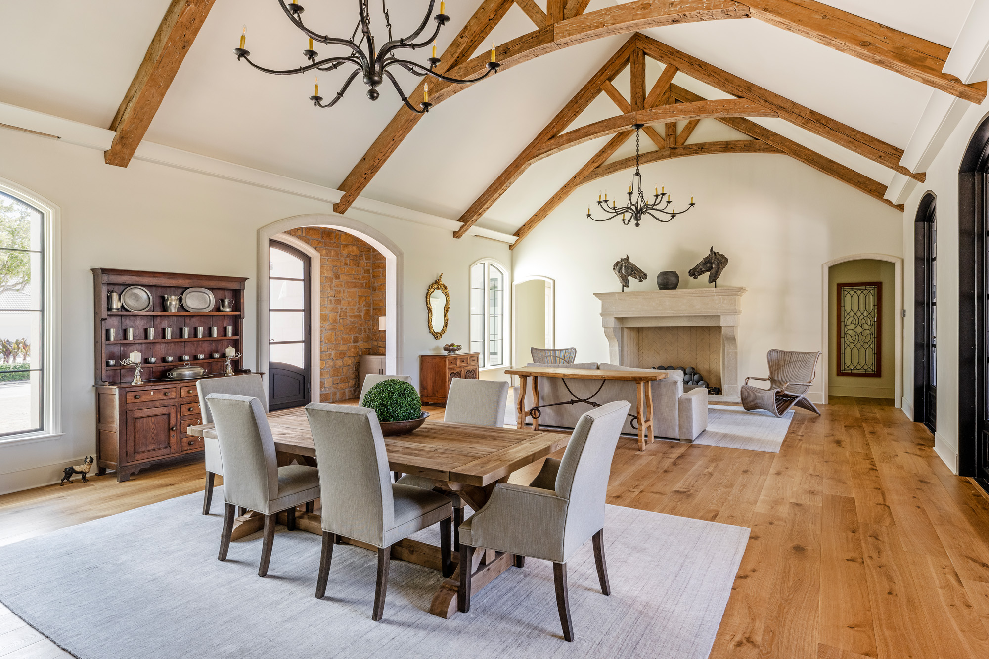 French Countryside dining room with wood beams and hurricane-rated windows