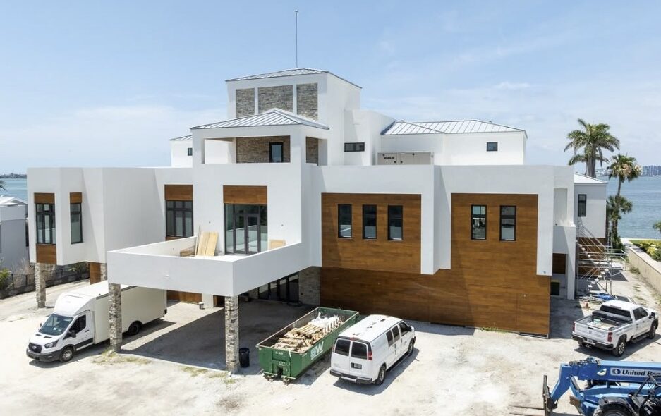 Construction photo of a Sarasota bayfront modern residence showing elevation, form, and coastal structural elements.
