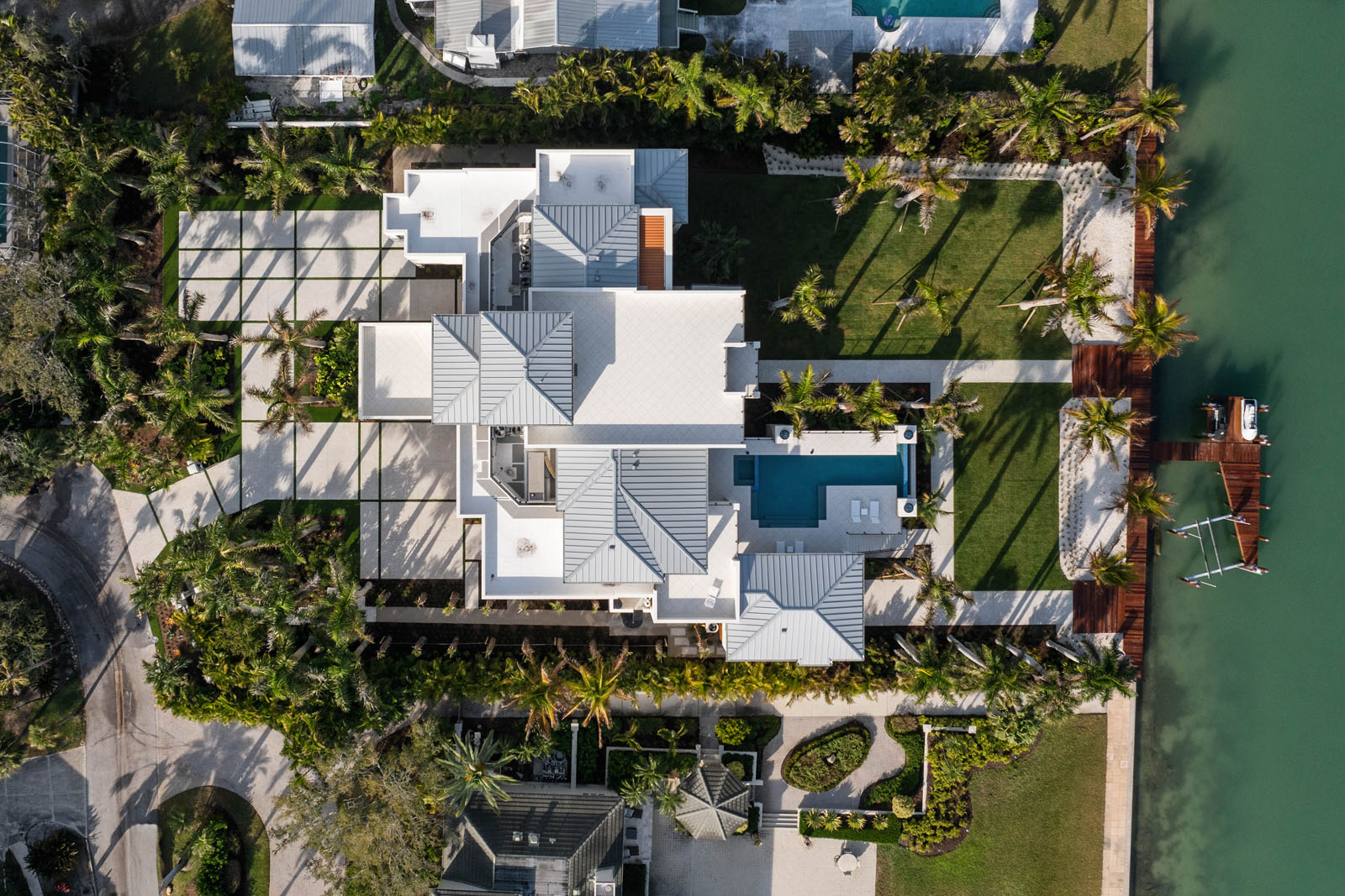 default Top view of modern waterfront residence with layered rooflines and coastal site layout