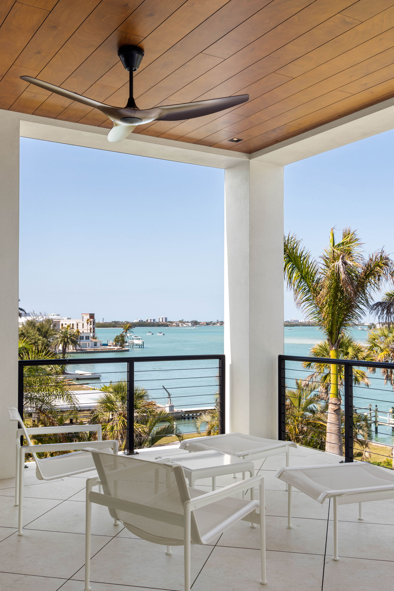 077_Norsota_Trinity_CMSA_RyanGammaPhotography_1 Covered terrace with seating overlooking Sarasota Bay in waterfront home